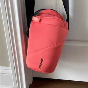 Corkcicle orangish sling bottle holder with extra storage for phone etc.